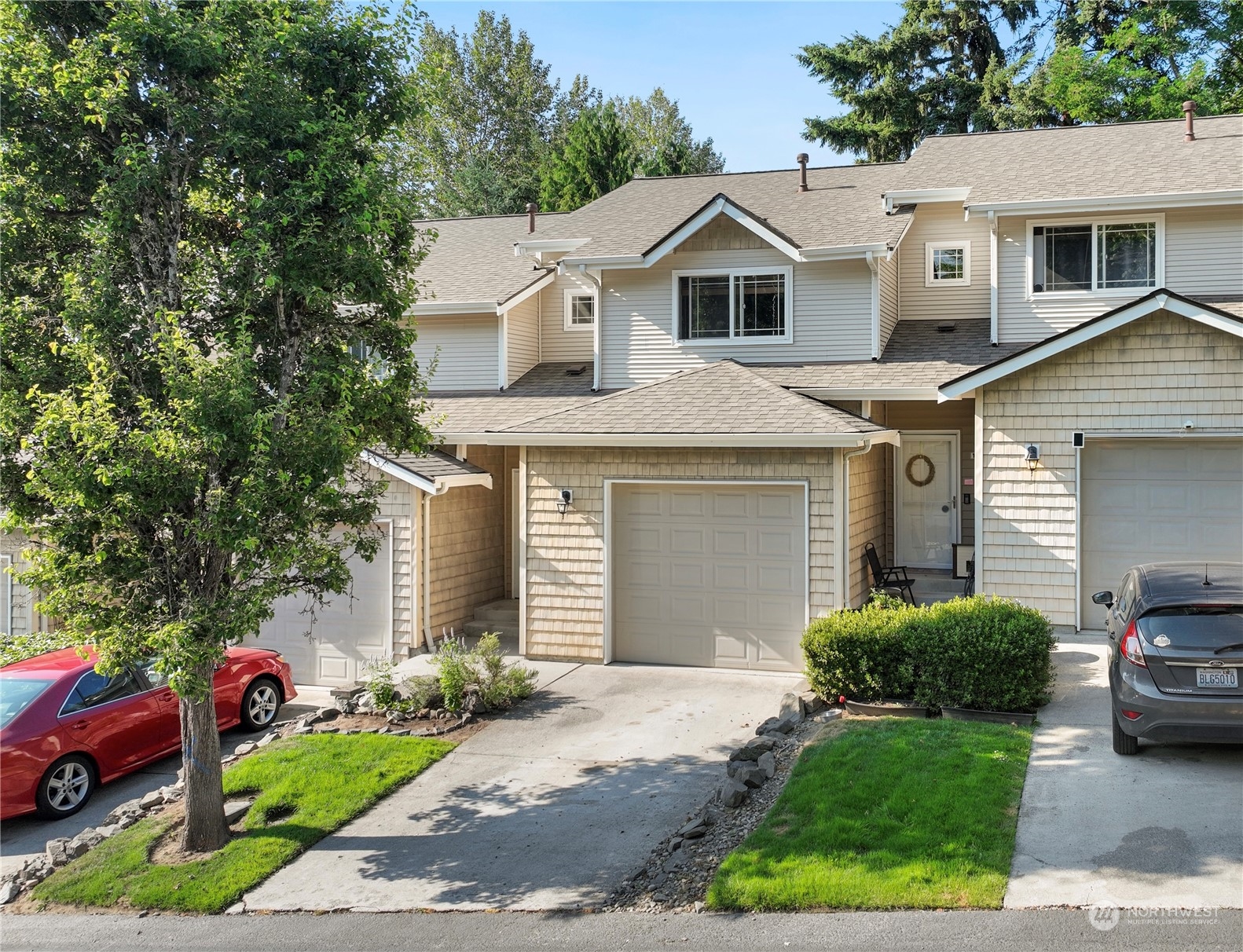 a front view of a house with a yard and garage