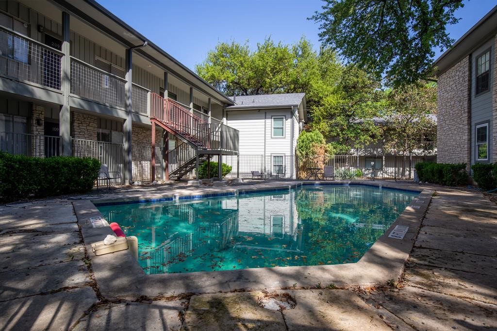 a view of a house with backyard and sitting area