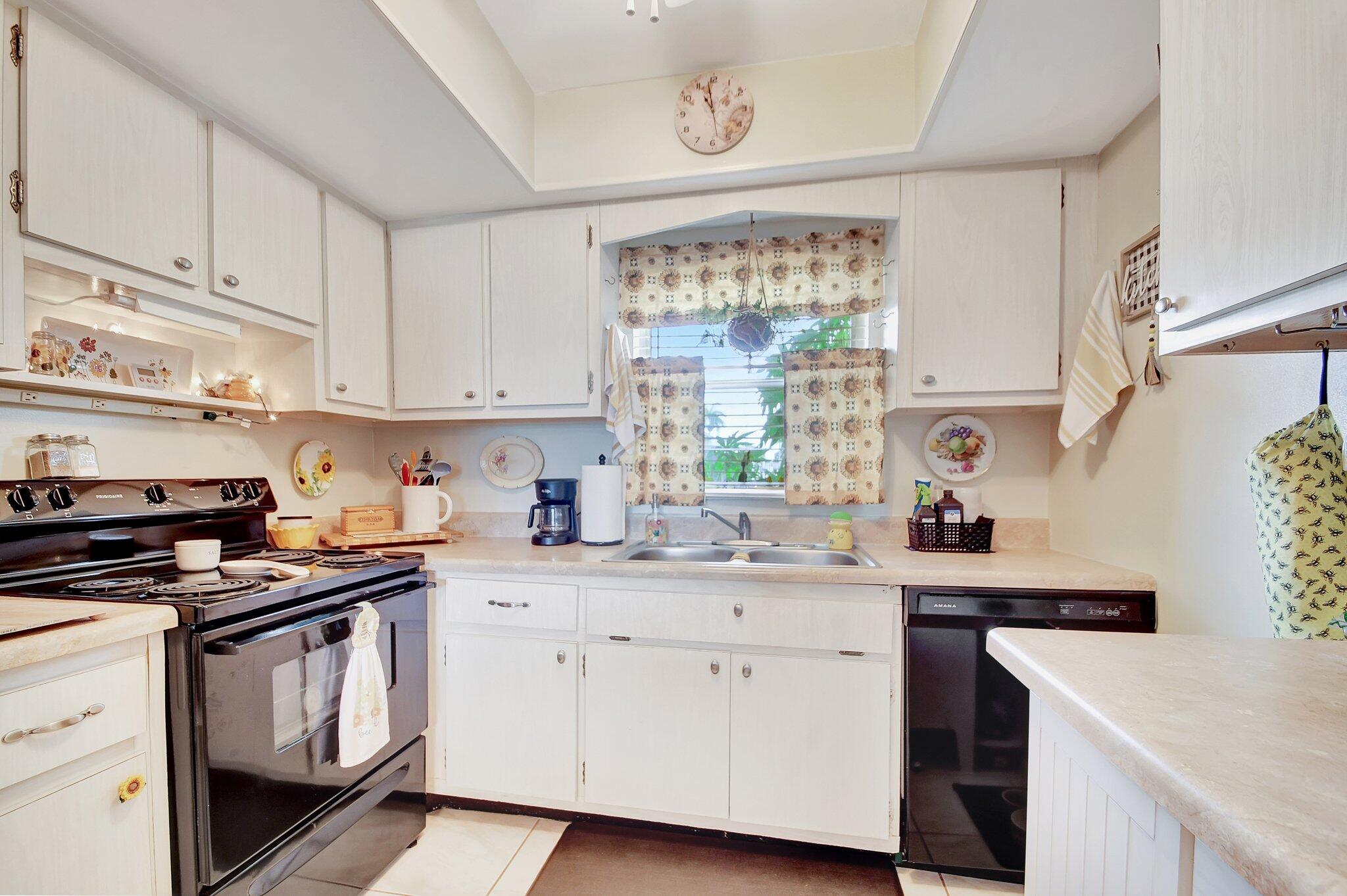 a kitchen with a sink stove top oven and cabinets