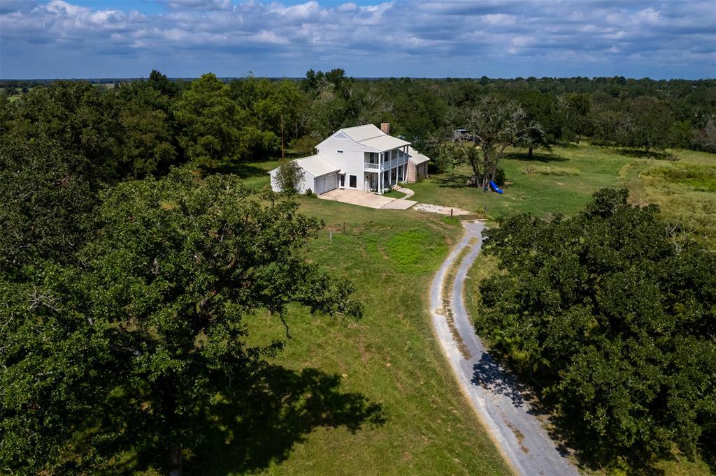 an aerial view of a house with a yard