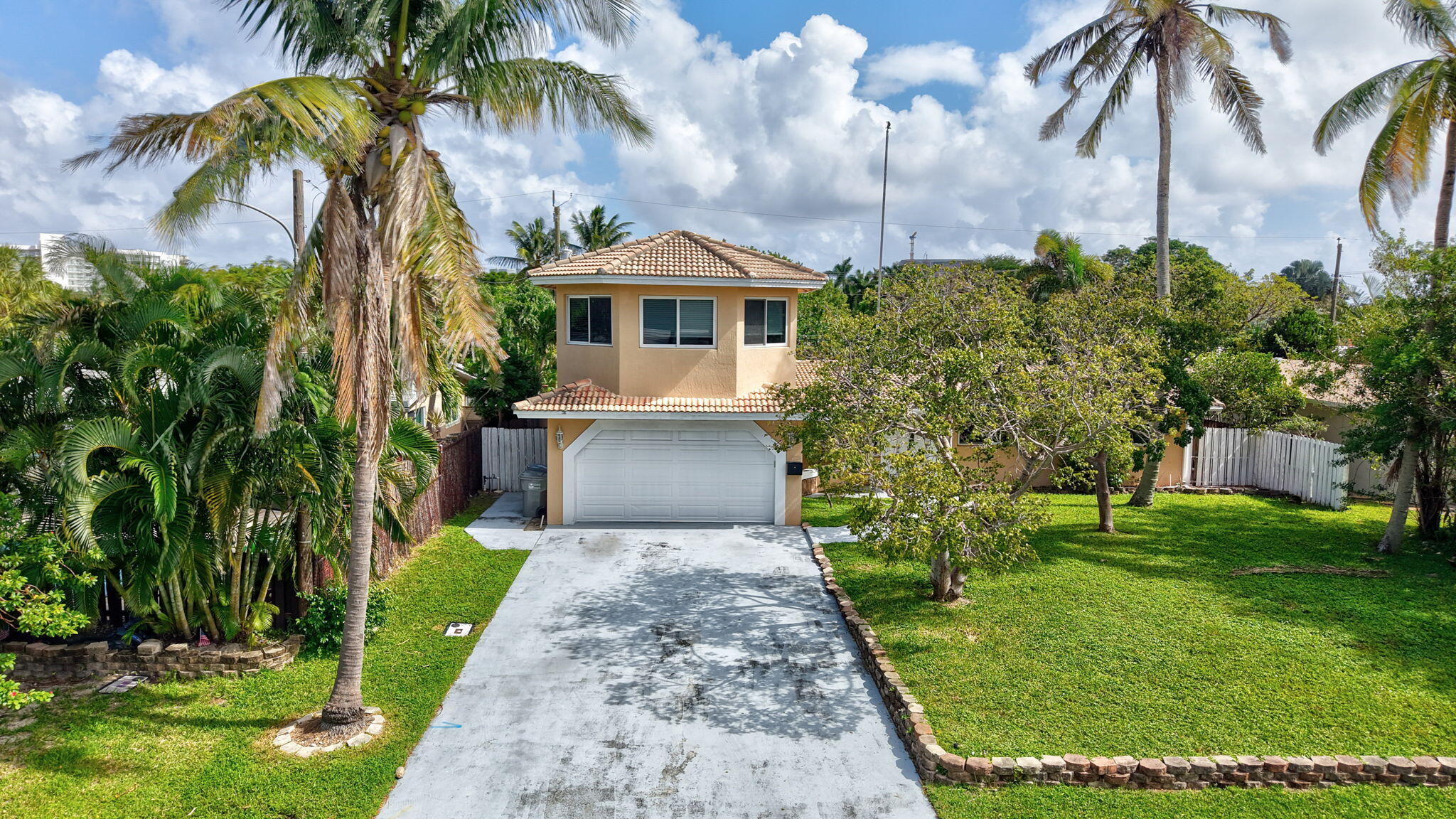 a front view of a house with a garden