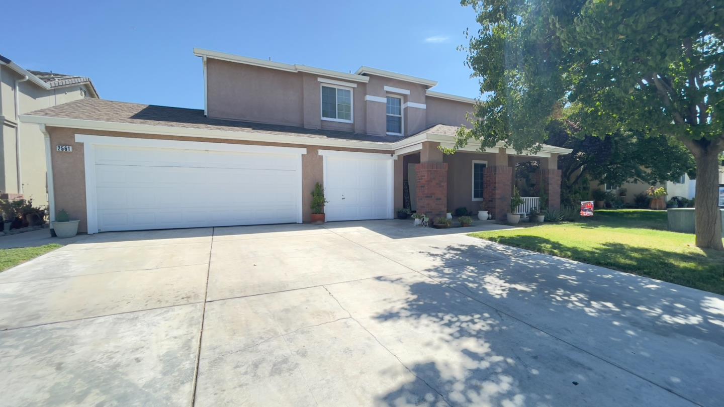 a view of a house with a yard and garage