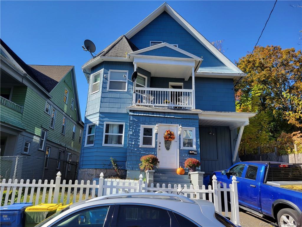 a front view of multiple houses with balcony