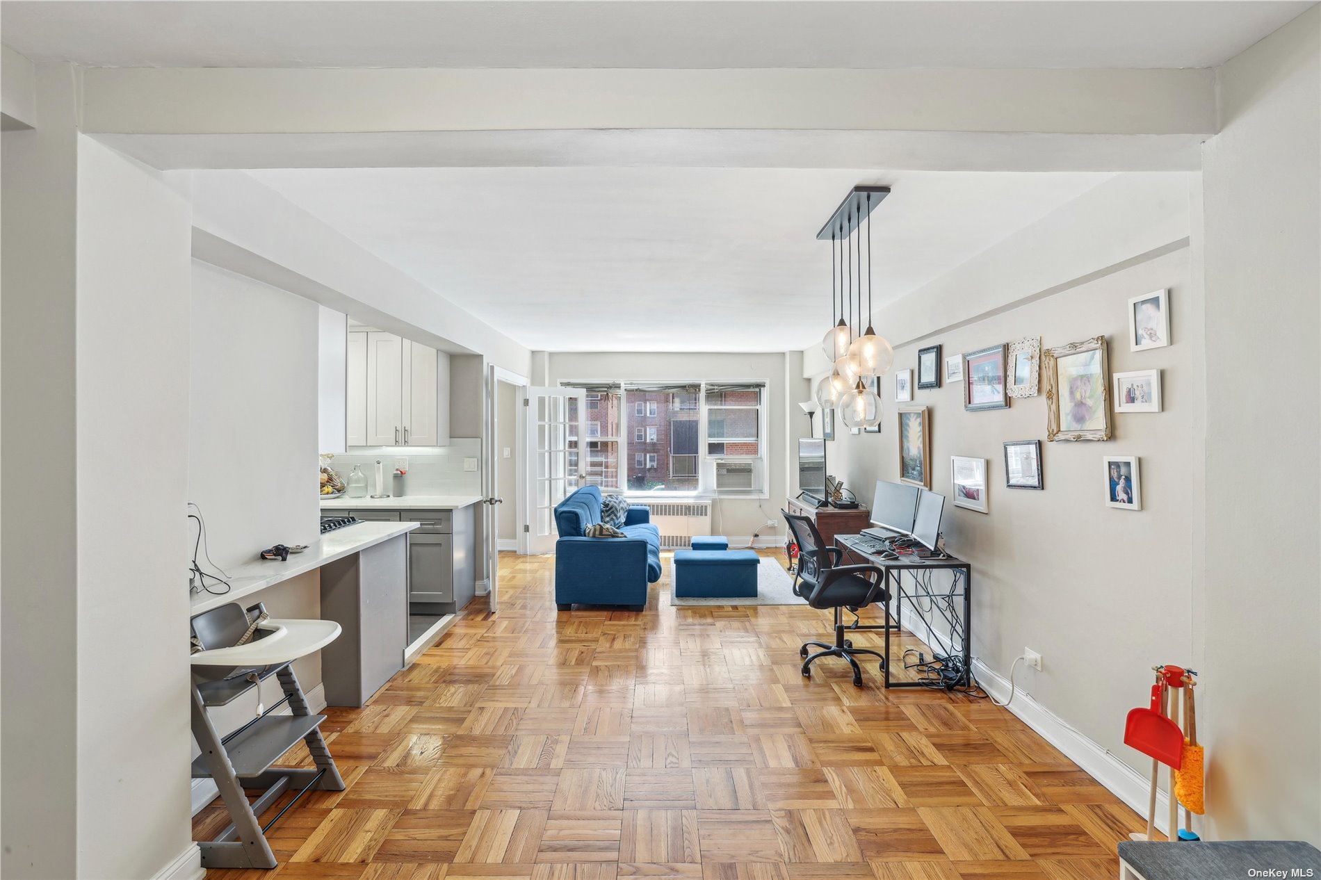 a living room with furniture a dining table and a large window