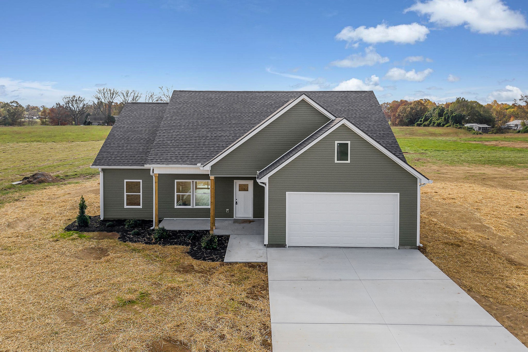 a front view of house with yard and mountain in the background