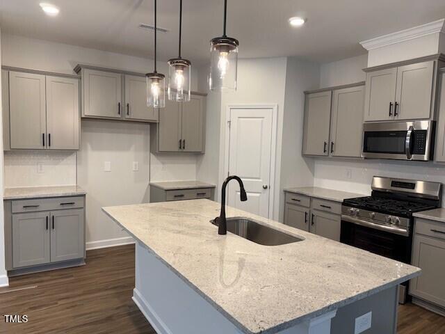 a kitchen with kitchen island granite countertop a sink a counter space stainless steel appliances and cabinets