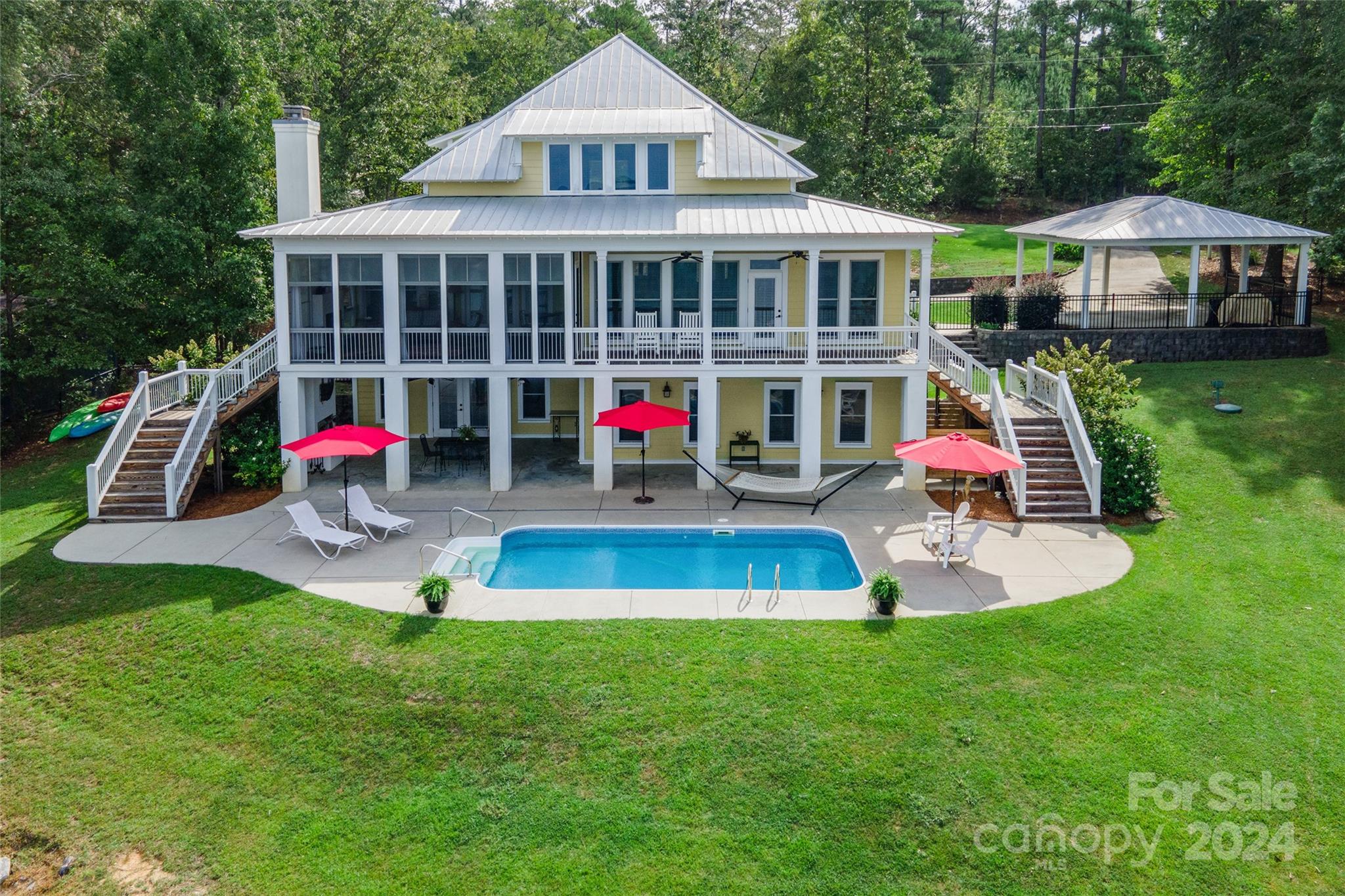 a view of a house with a yard patio and swimming pool