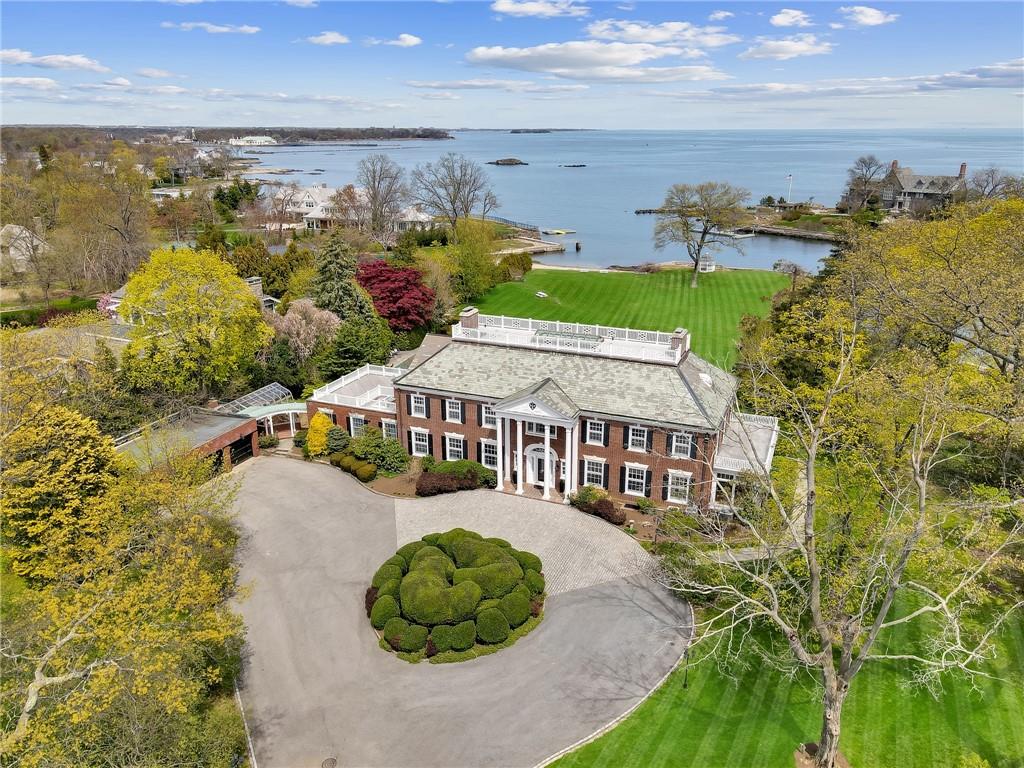 an aerial view of a house with a garden and lake view