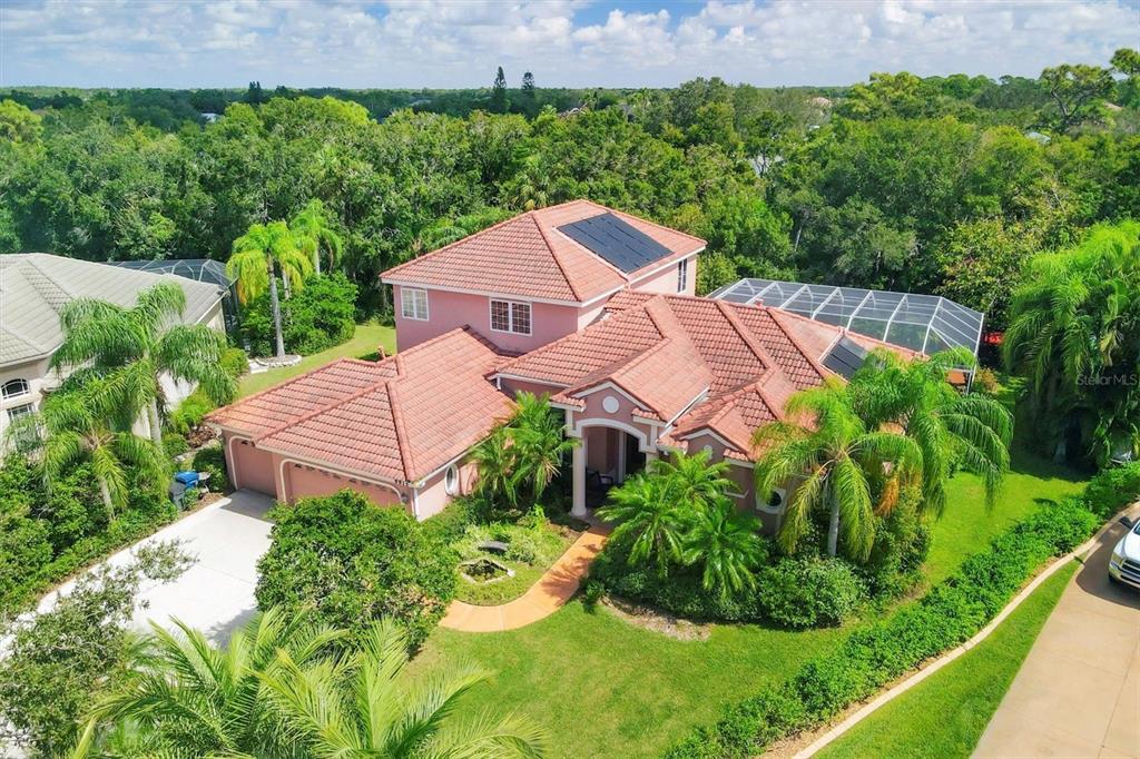 an aerial view of a house with garden space and a street view