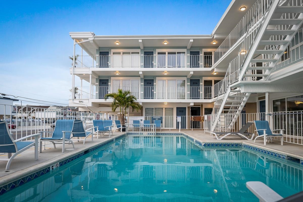 a swimming pool view with a outdoor seating