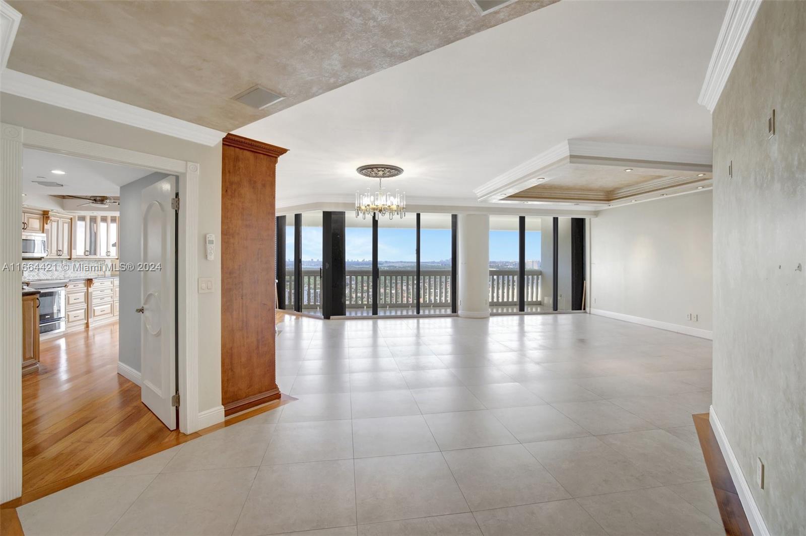 a view of an entryway with floor to ceiling windows and a room