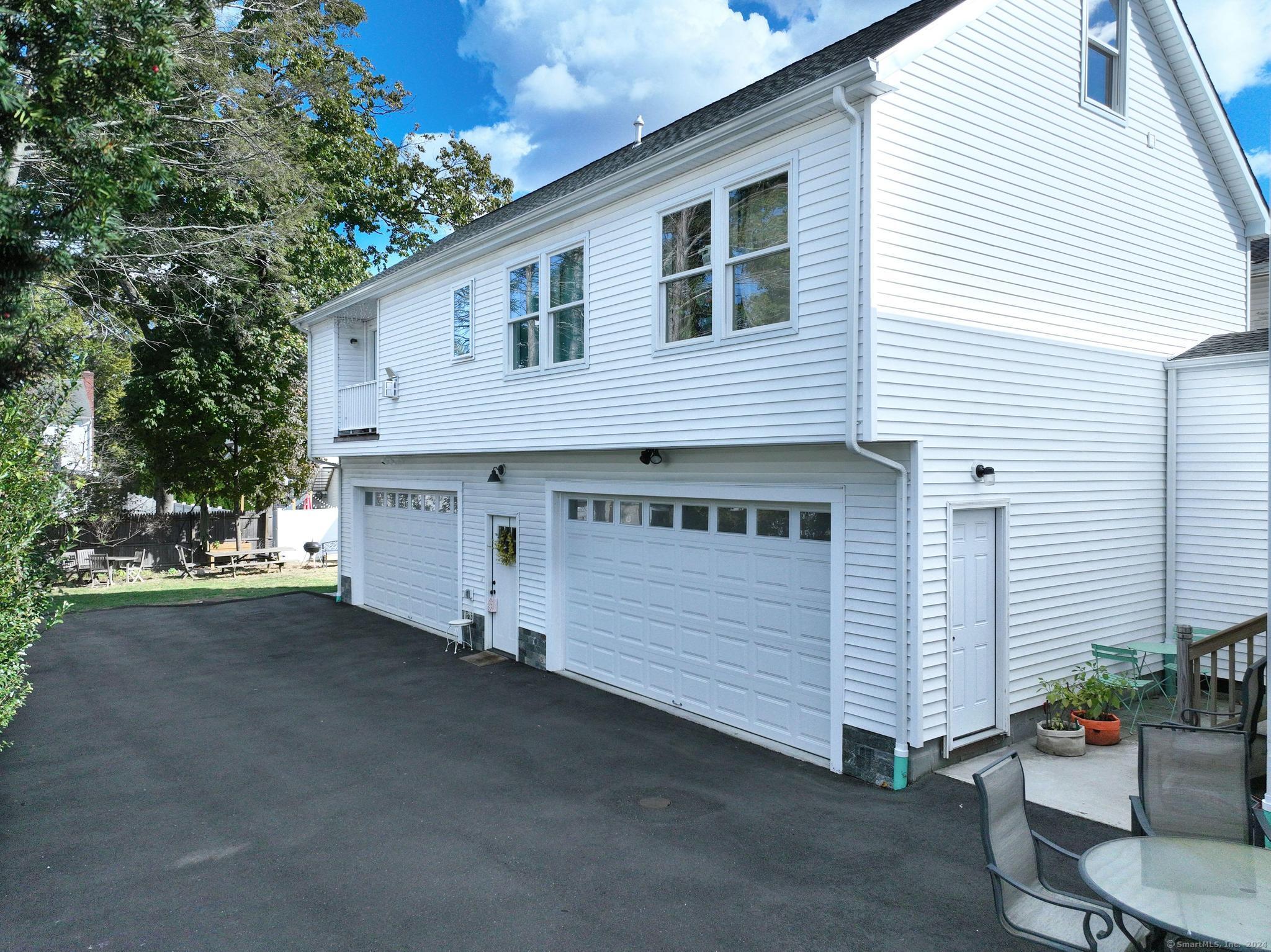 a view of a house with a yard and garage