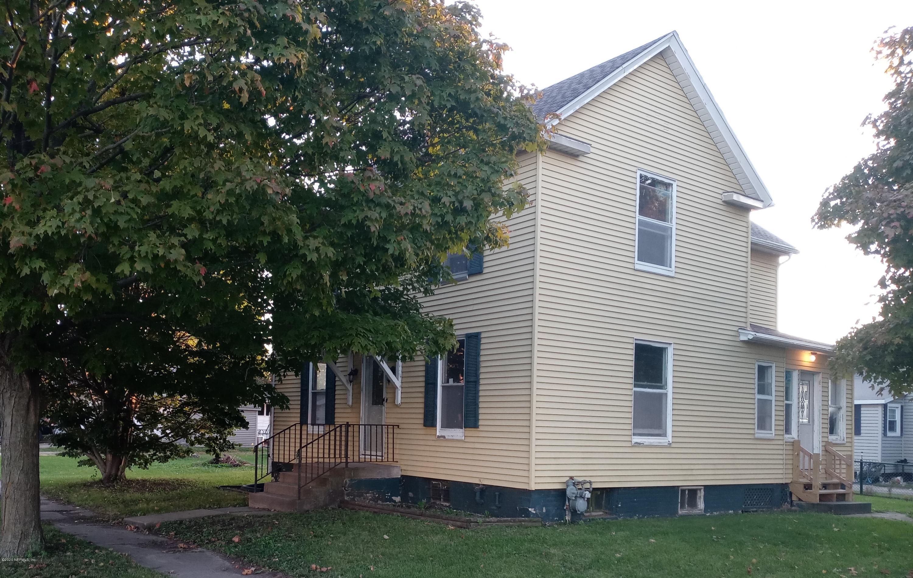 a view of house with backyard