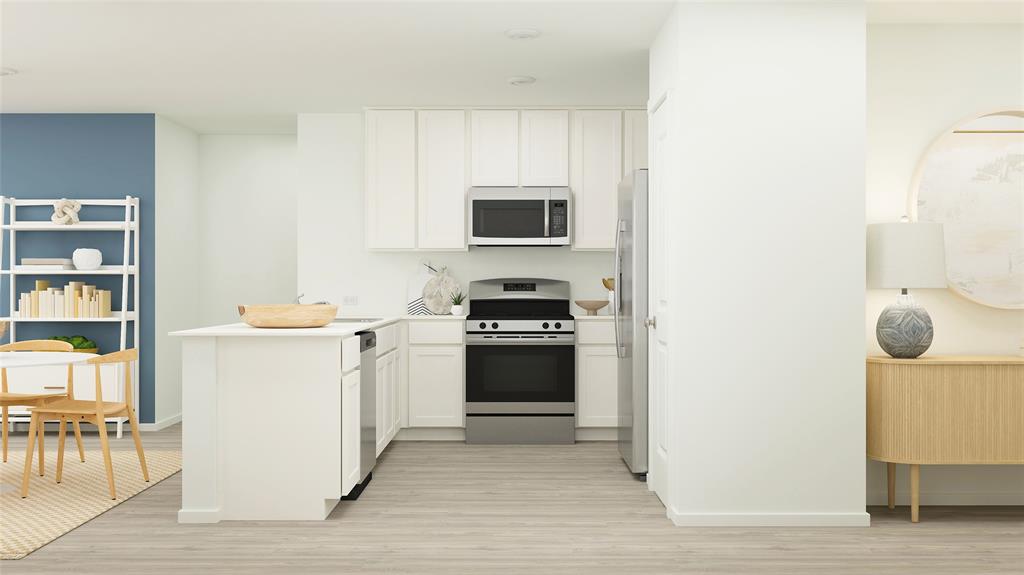 a kitchen with a refrigerator and a stove top oven