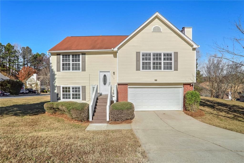 a front view of a house with a yard and garage