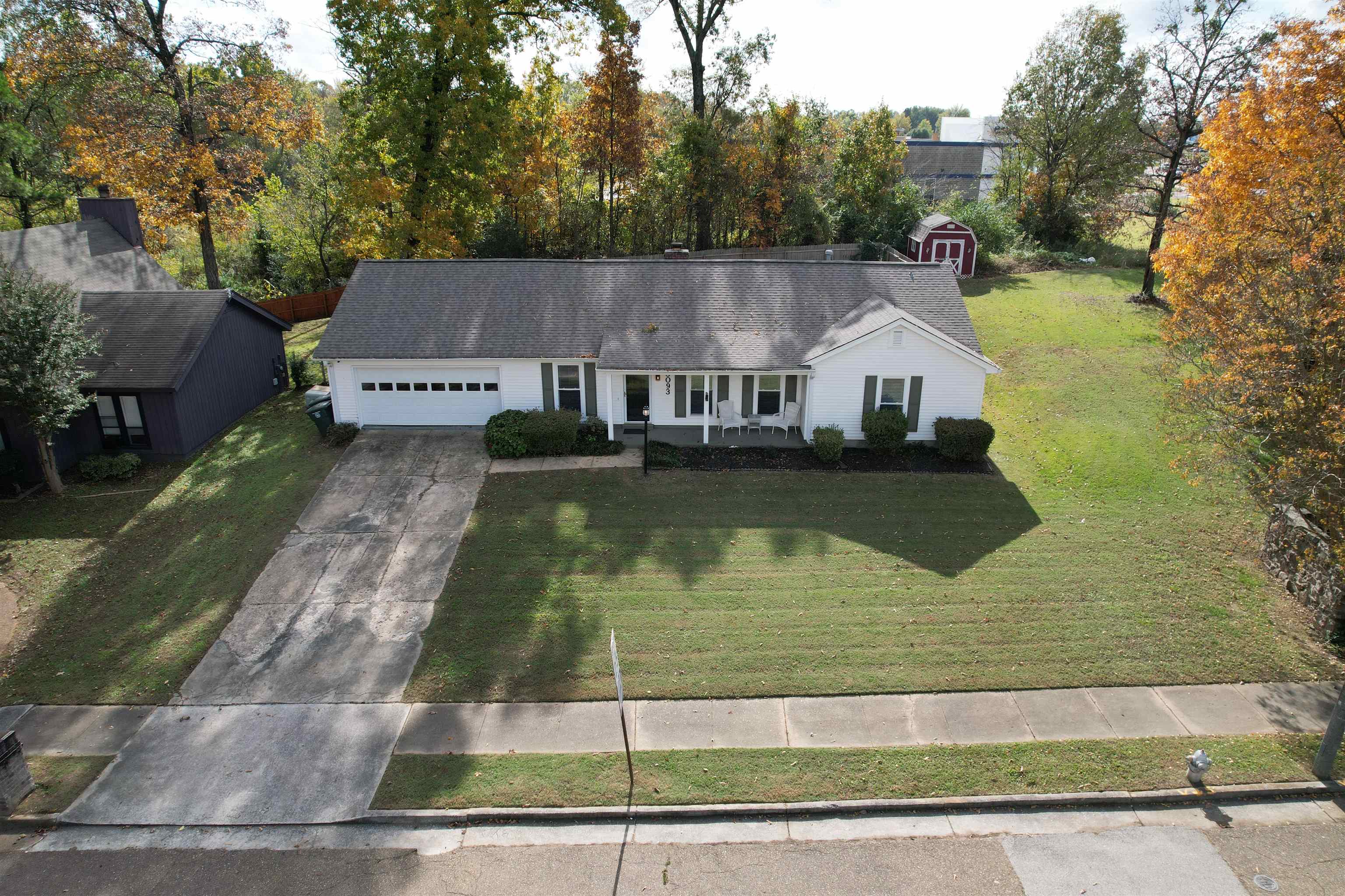 View of front of house featuring a front lawn and a garage