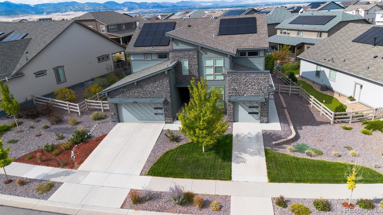 an aerial view of a house with a yard