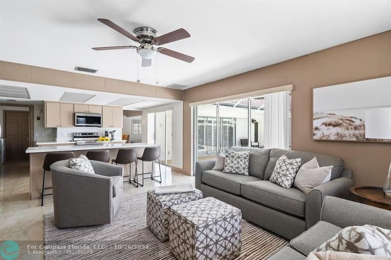 a living room with furniture ceiling fan and a rug