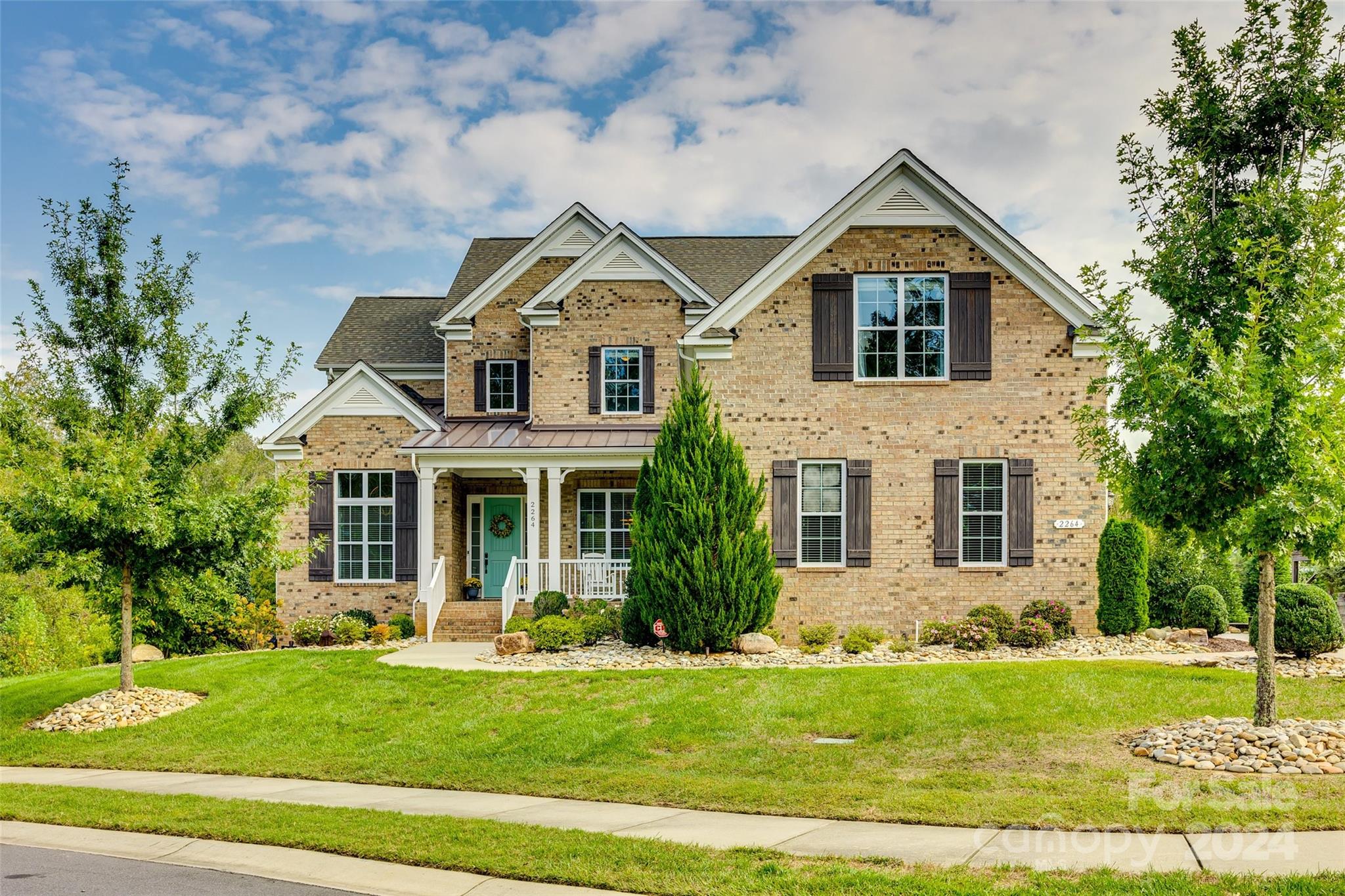 a front view of a house with a yard