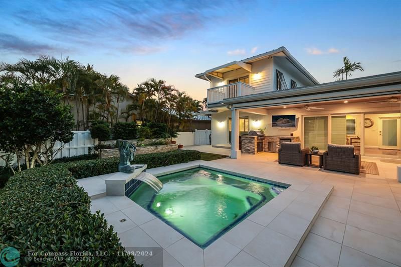 a view of a house with swimming pool and sitting area