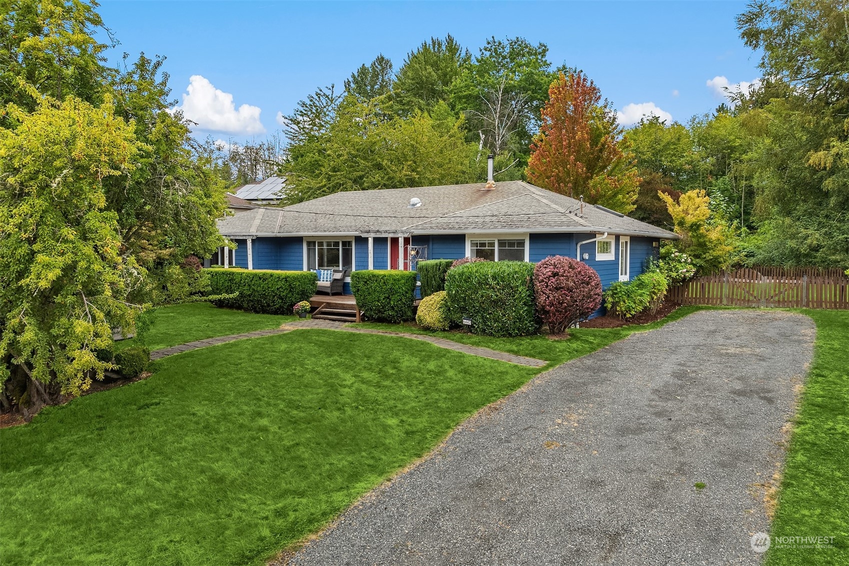 a front view of a house with a garden