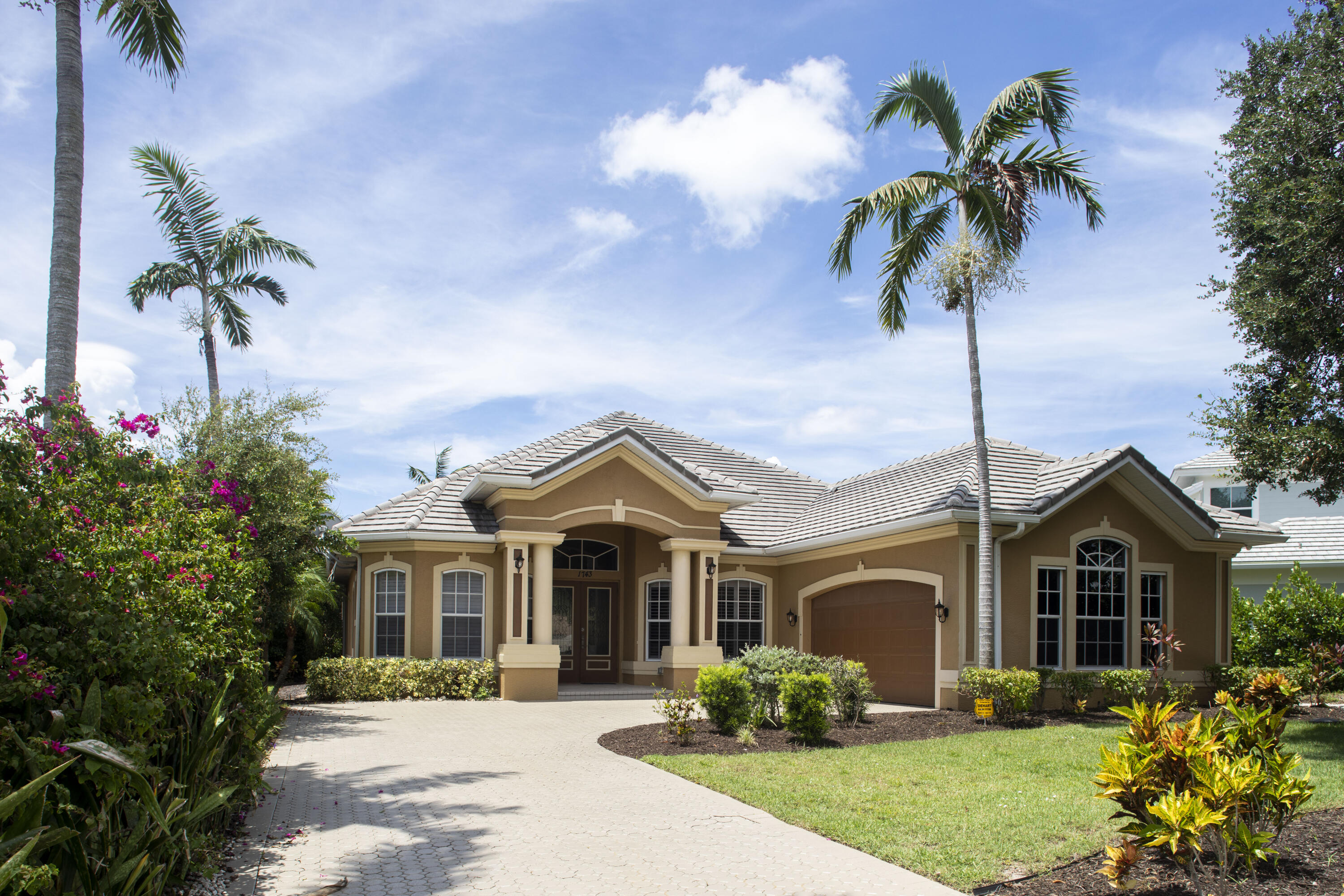 a front view of a house with a garden