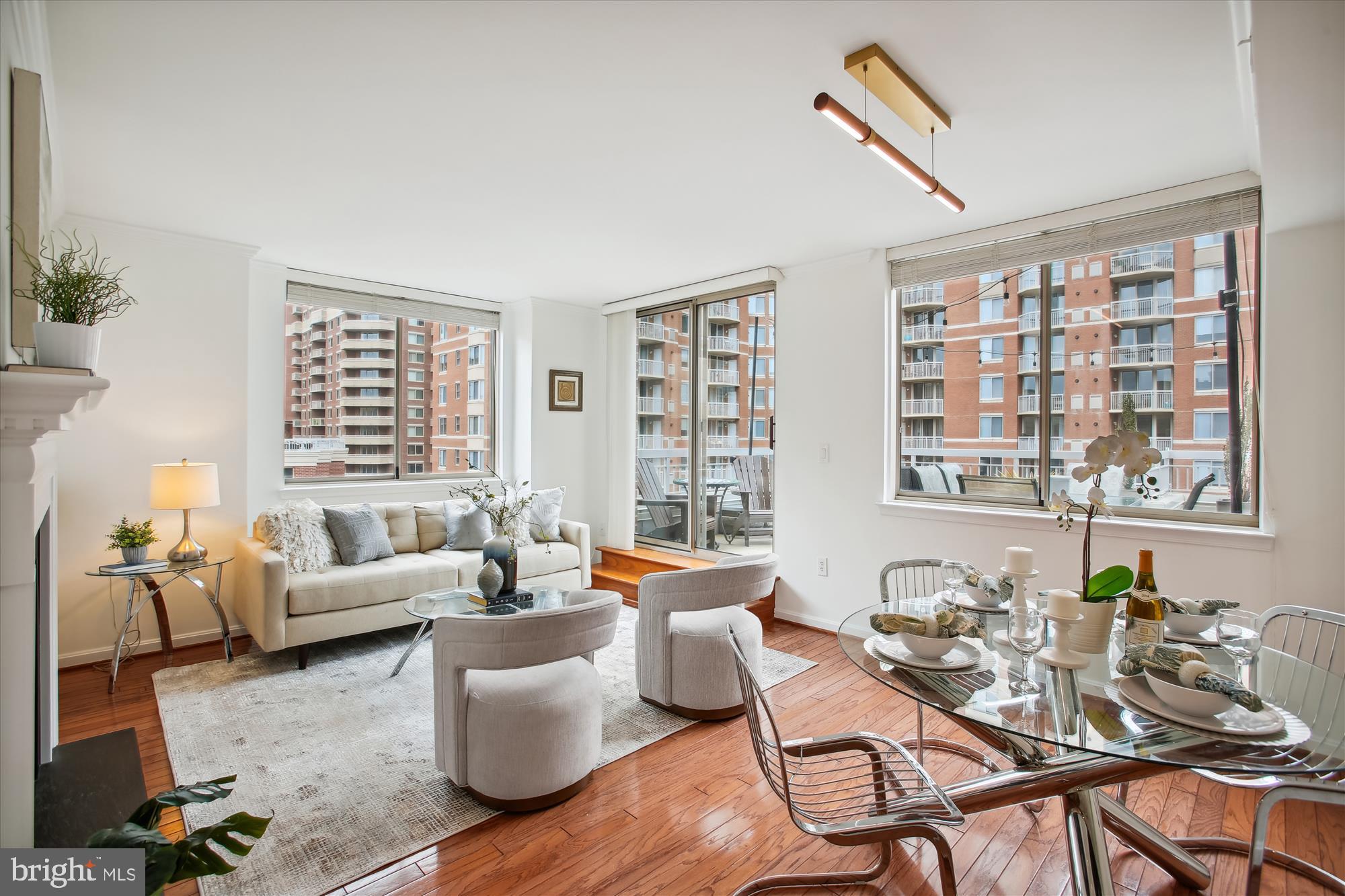 a living room with furniture and floor to ceiling windows