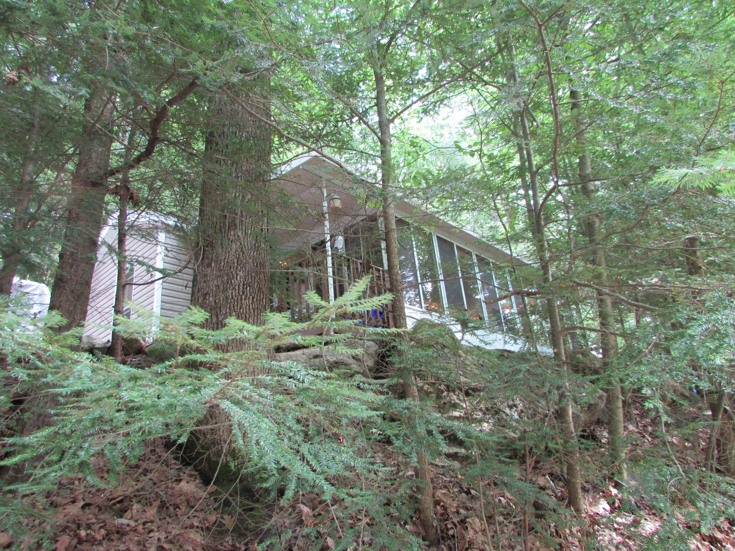 a view of a house with a yard and sitting area