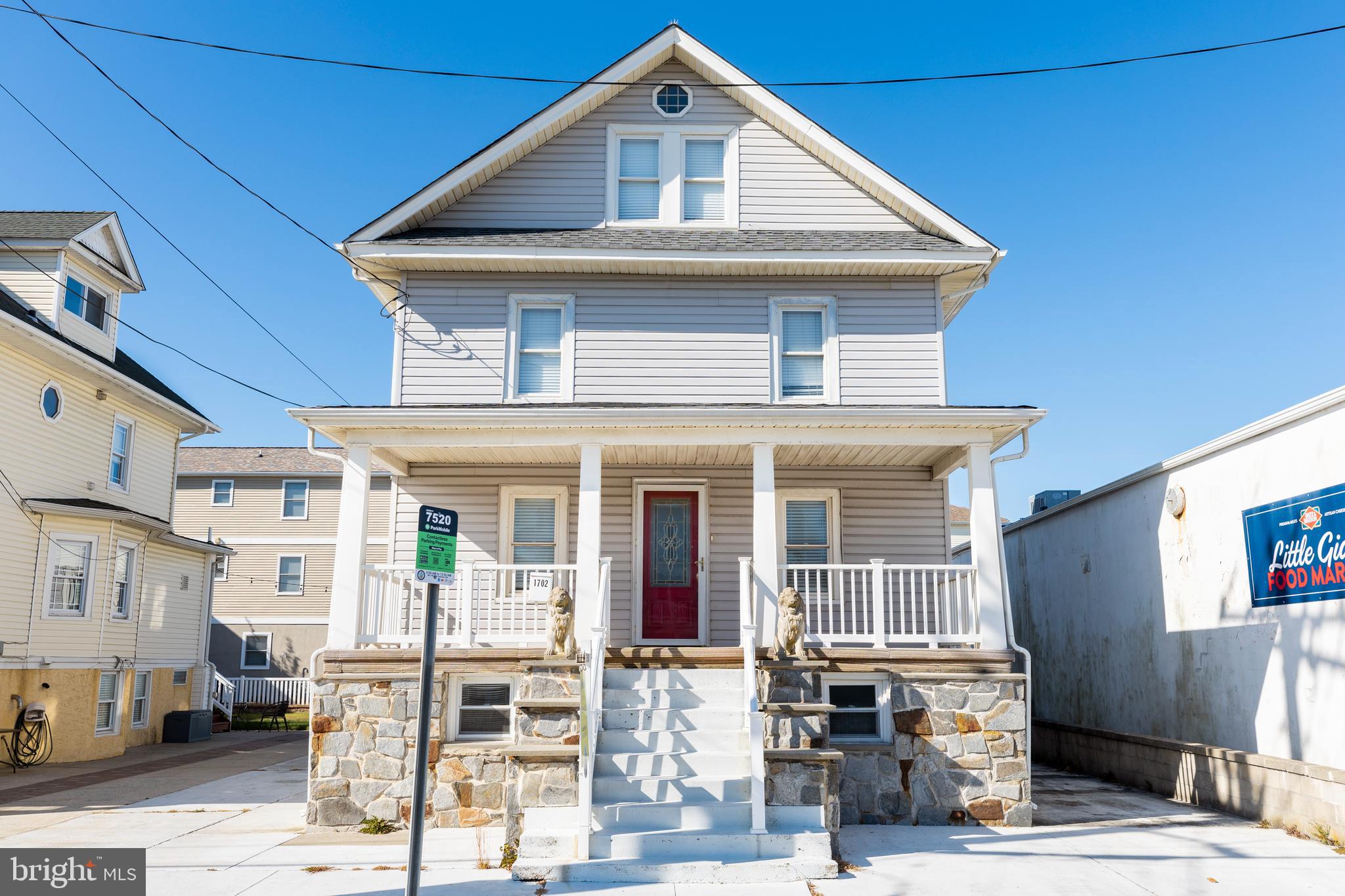 a front view of a house with outdoor seating