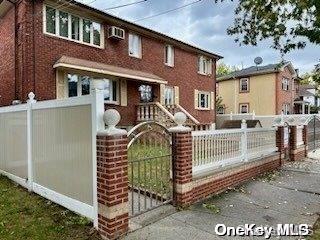 a front view of a house with iron fence