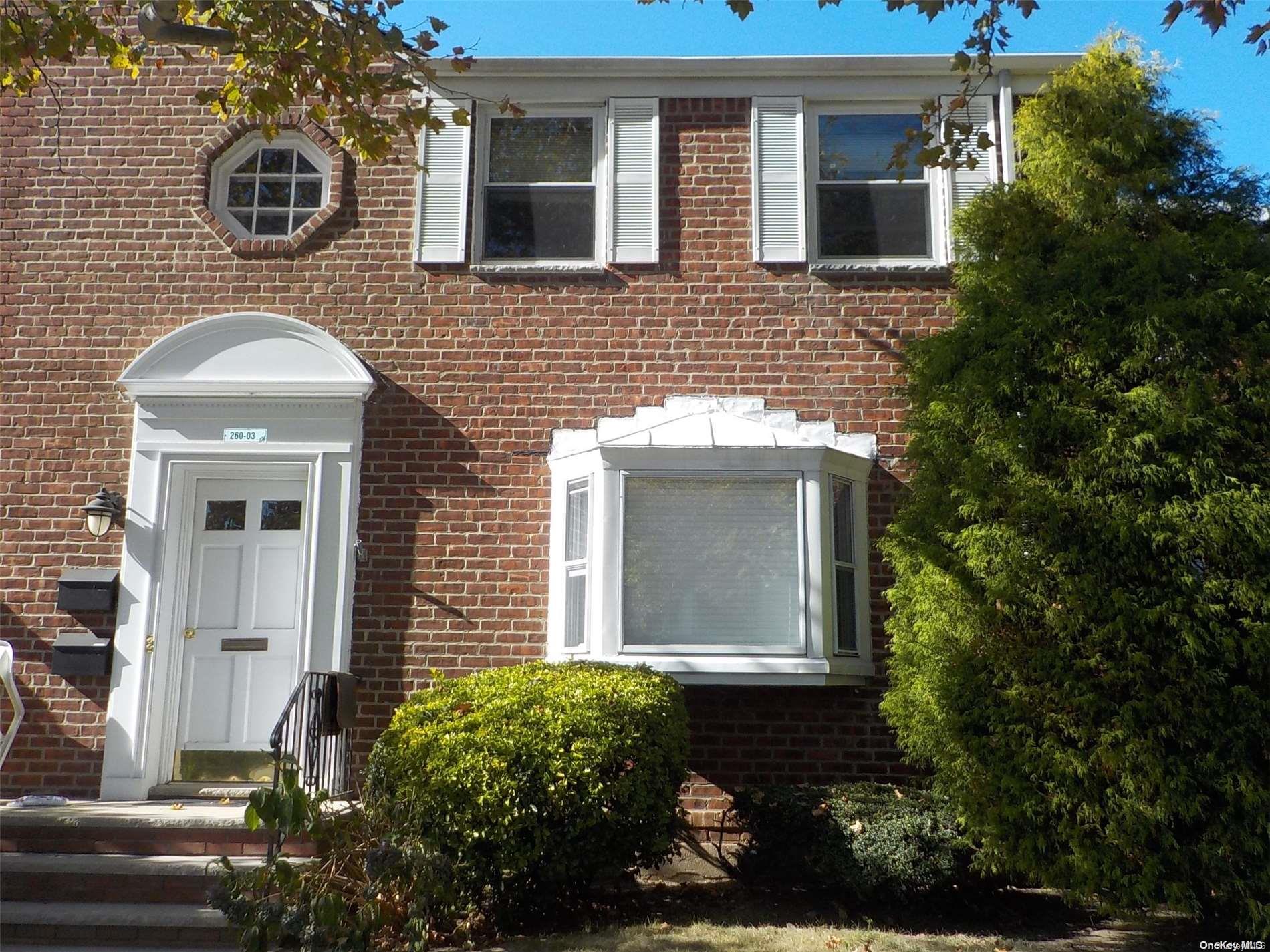 a front view of a house with yard