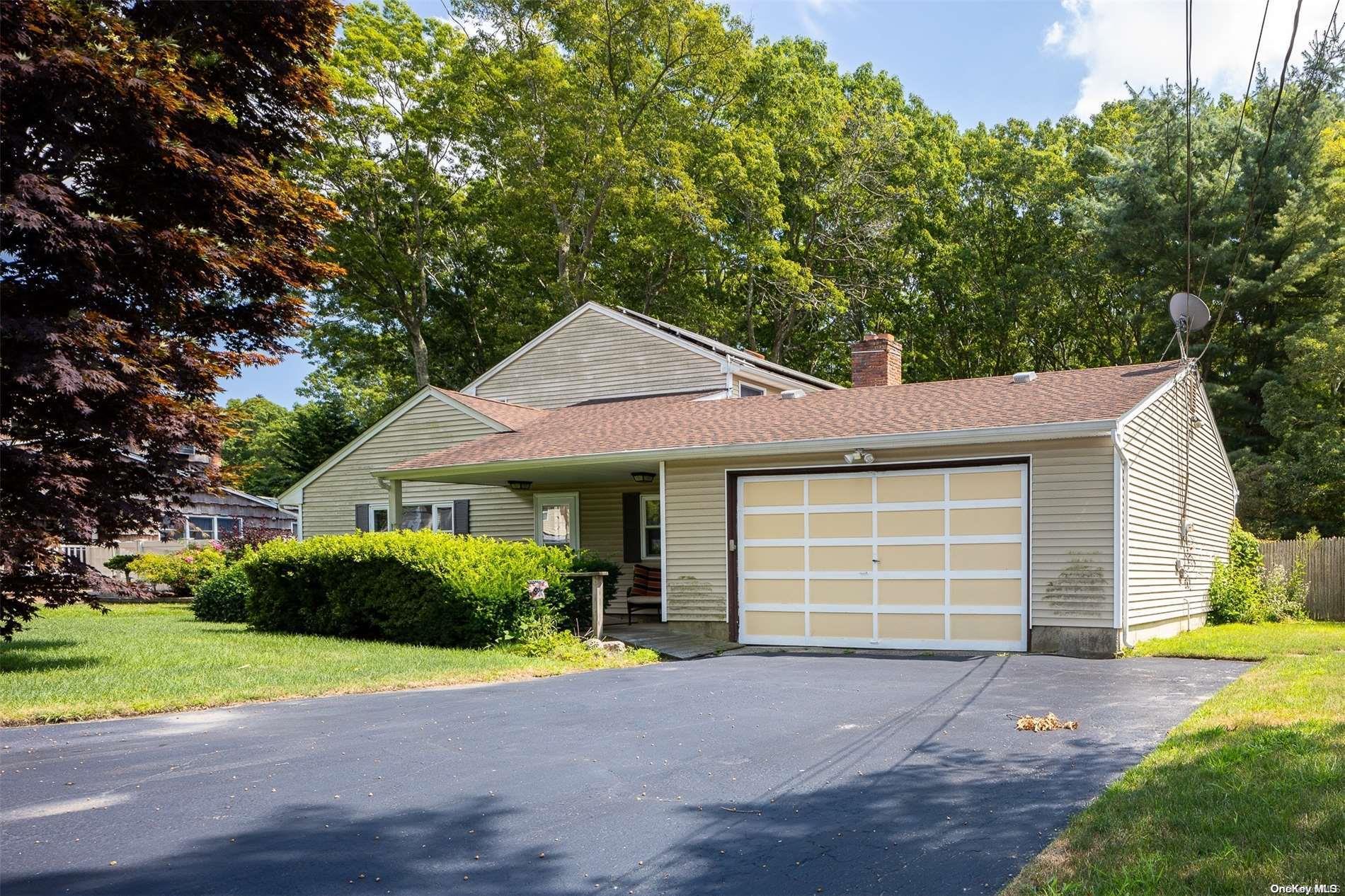 a front view of a house with a garden and garage