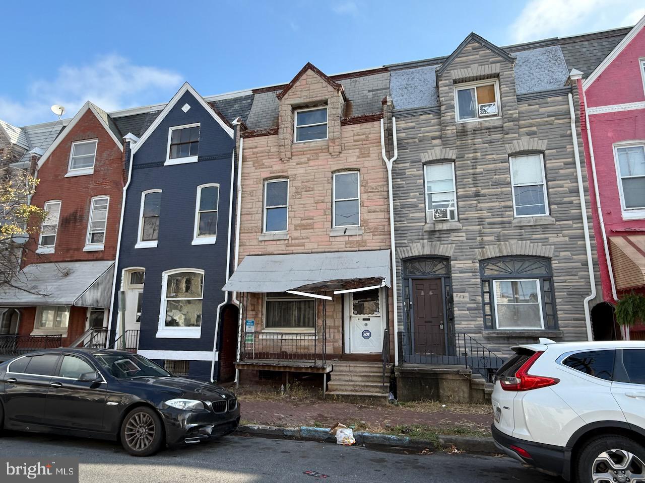 a car parked in front of a brick house