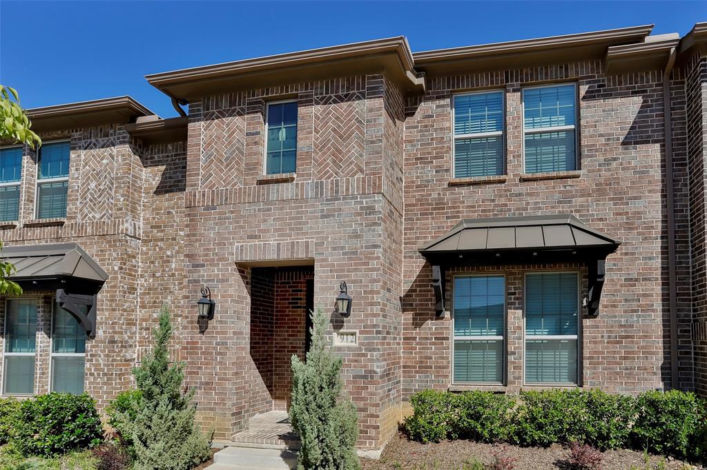 a front view of a house with brick walls and windows