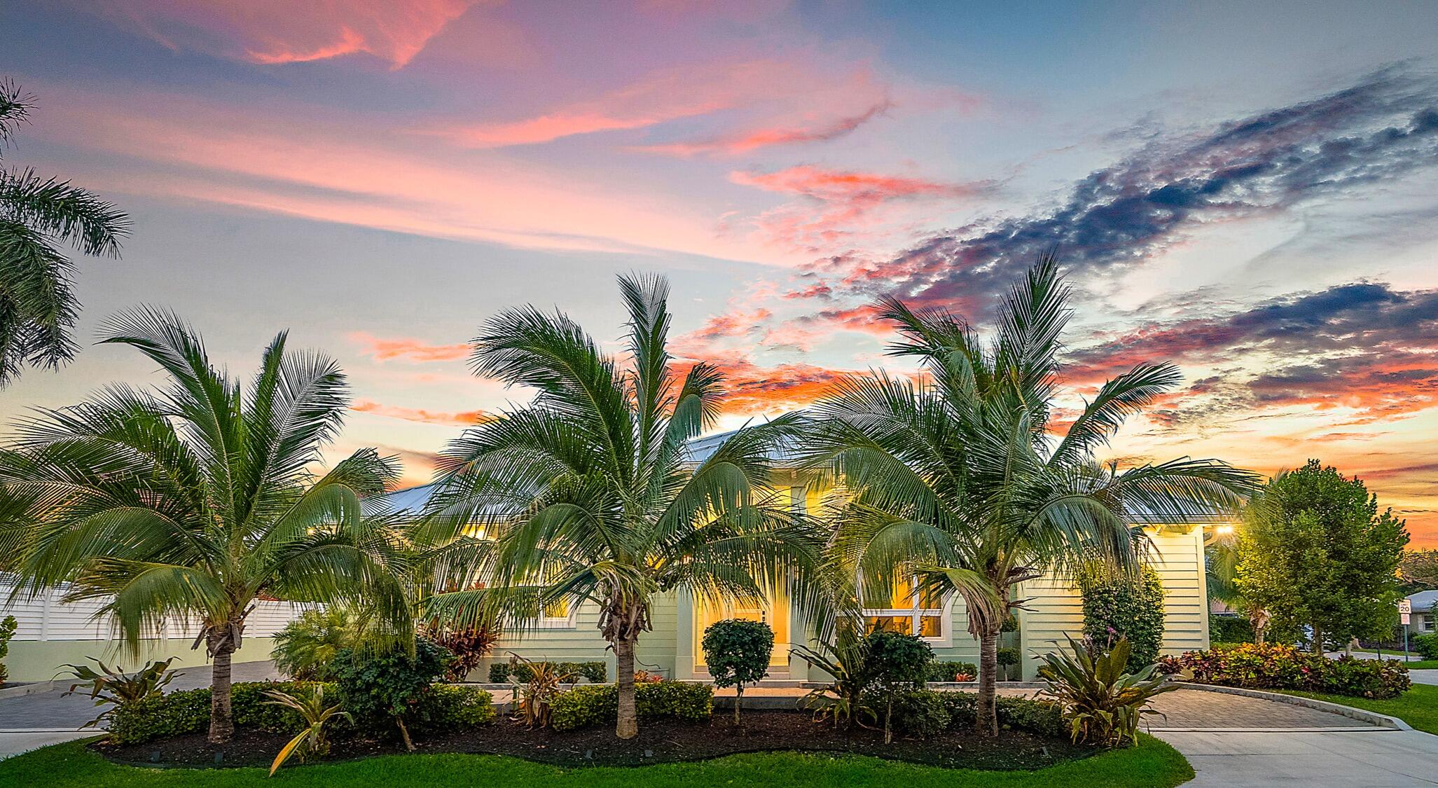 a front view of house with palm trees