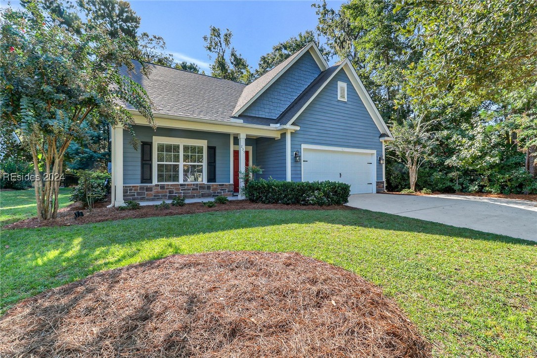 Featuring a striking red front door, elegant blue