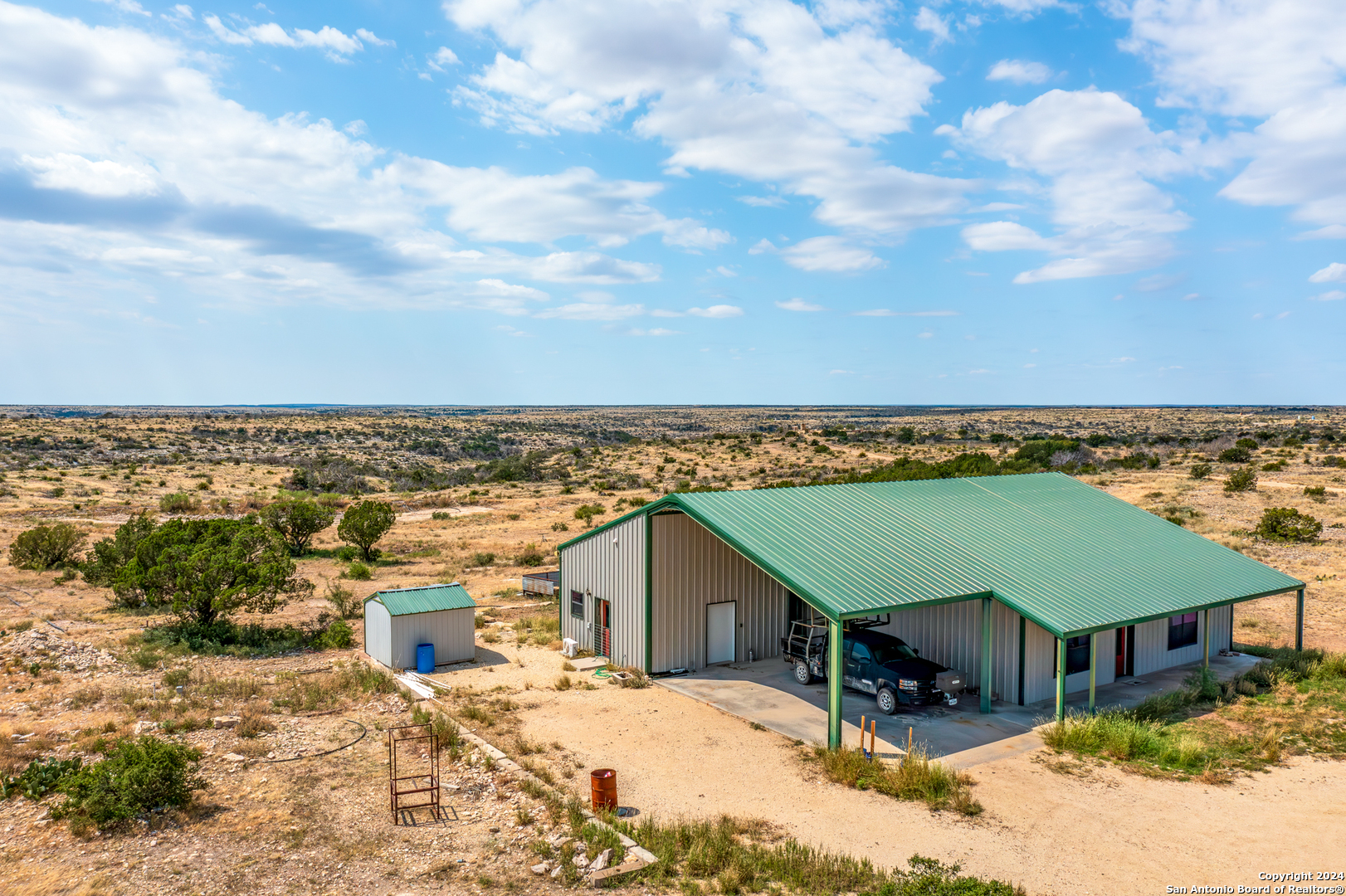 an aerial view of a house with a yard