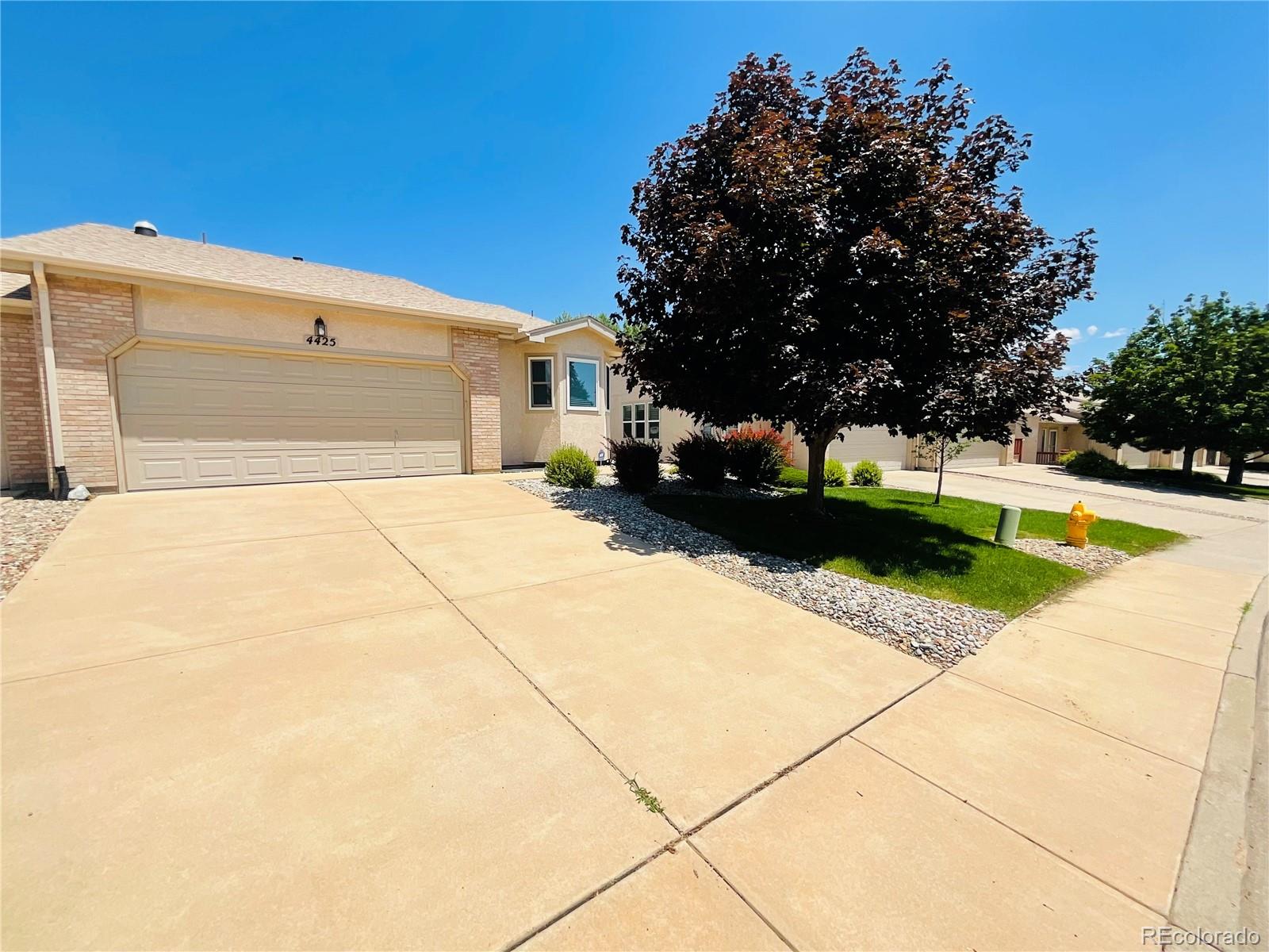 a view of garage with yard