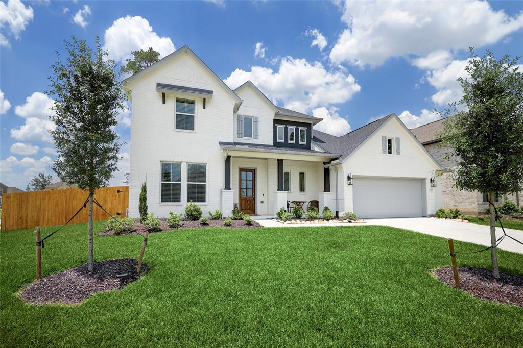 a front view of a house with a yard and entertaining space