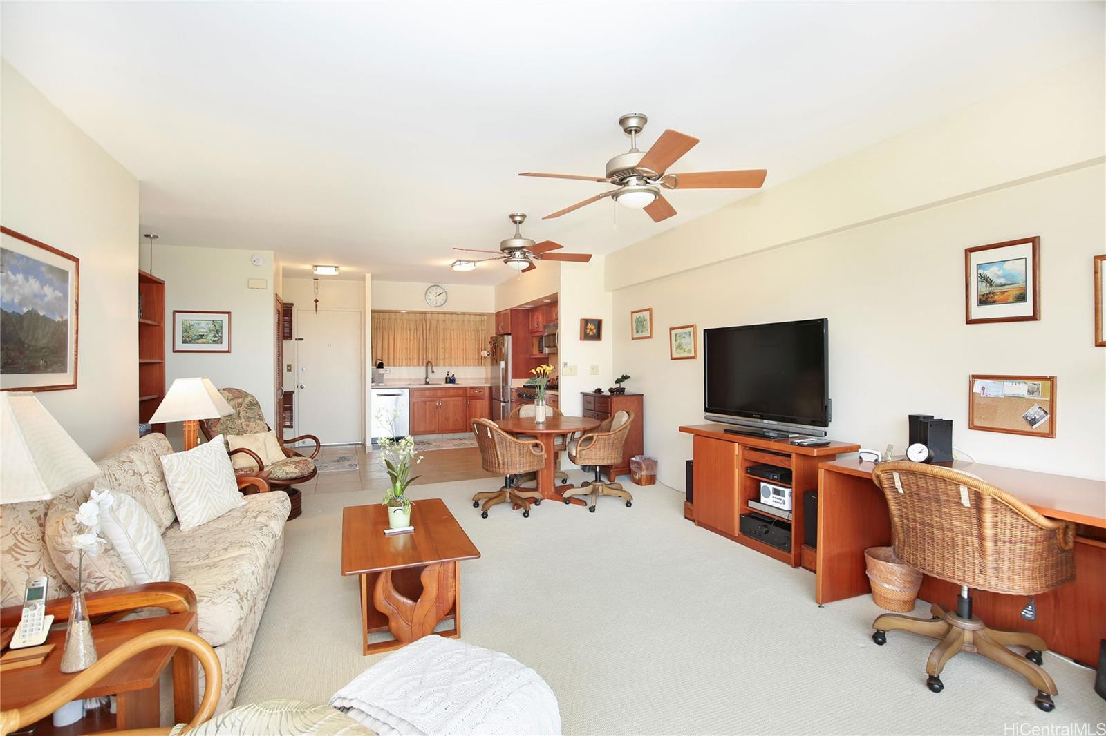 a view of a livingroom with workspace and a couch