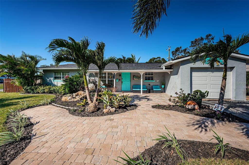 a front view of a house with a garden and patio