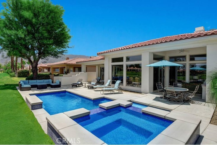 a view of a backyard with sitting area