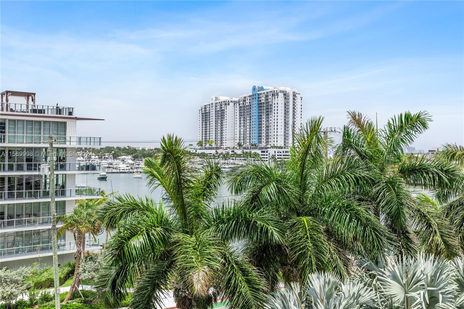 a view of a city with tall buildings and a bench