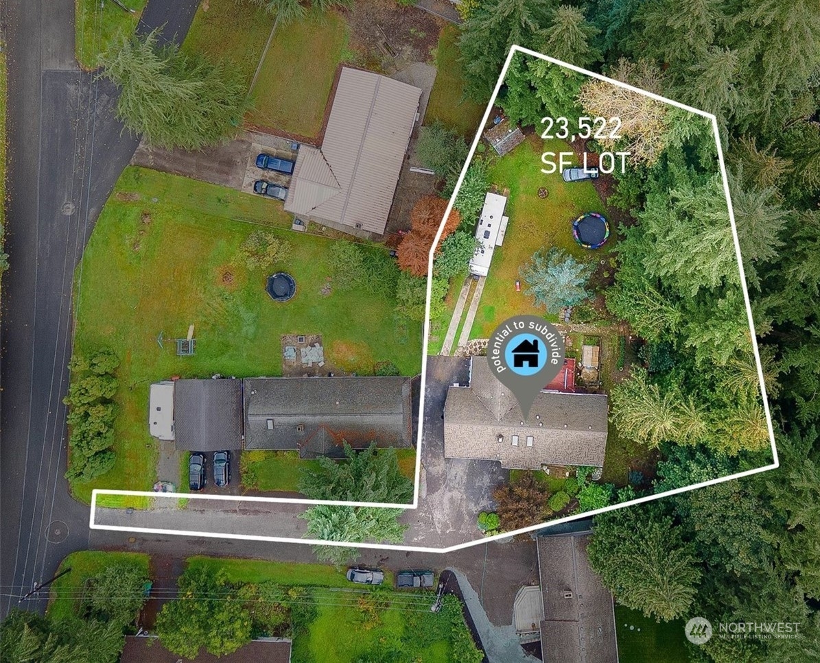 an aerial view of a house with a yard