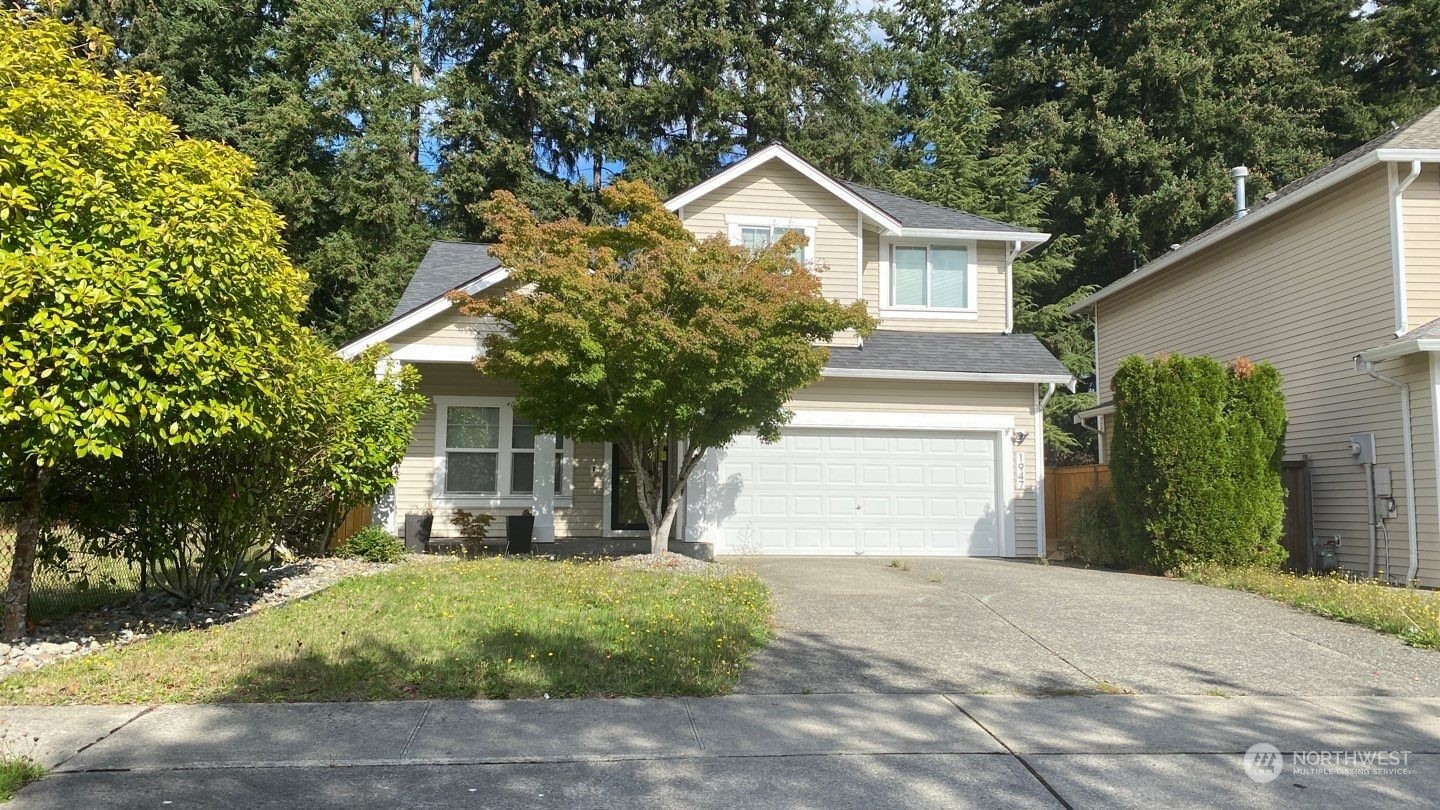 a front view of a house with a yard and garage