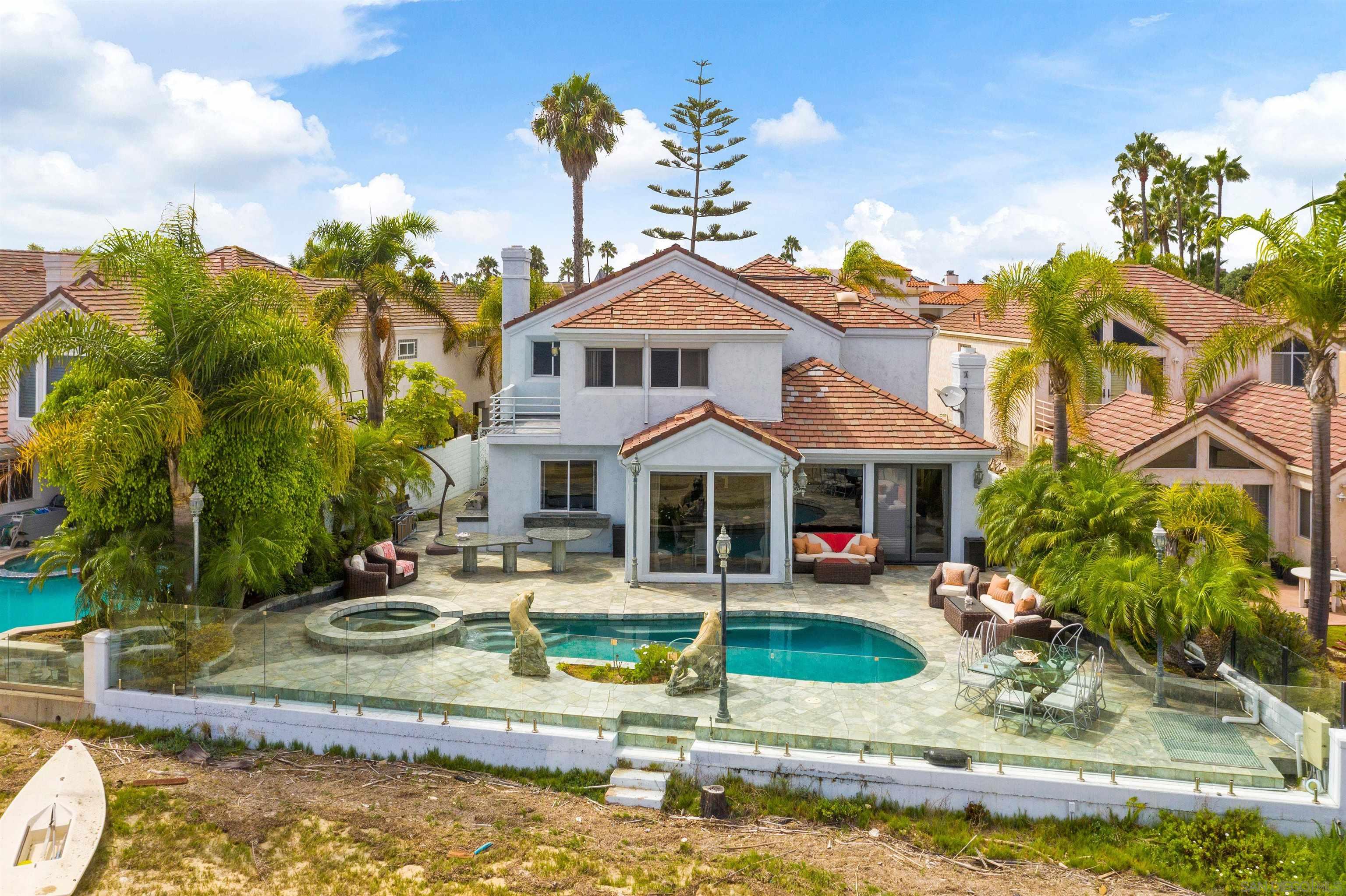 a front view of a house with swimming pool and a yard