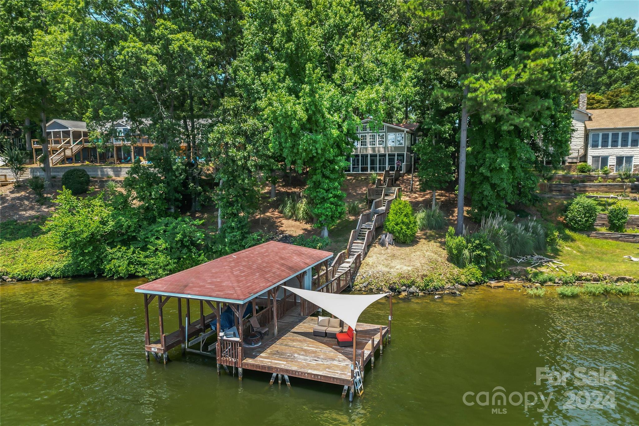 a view of house with yard and lake view