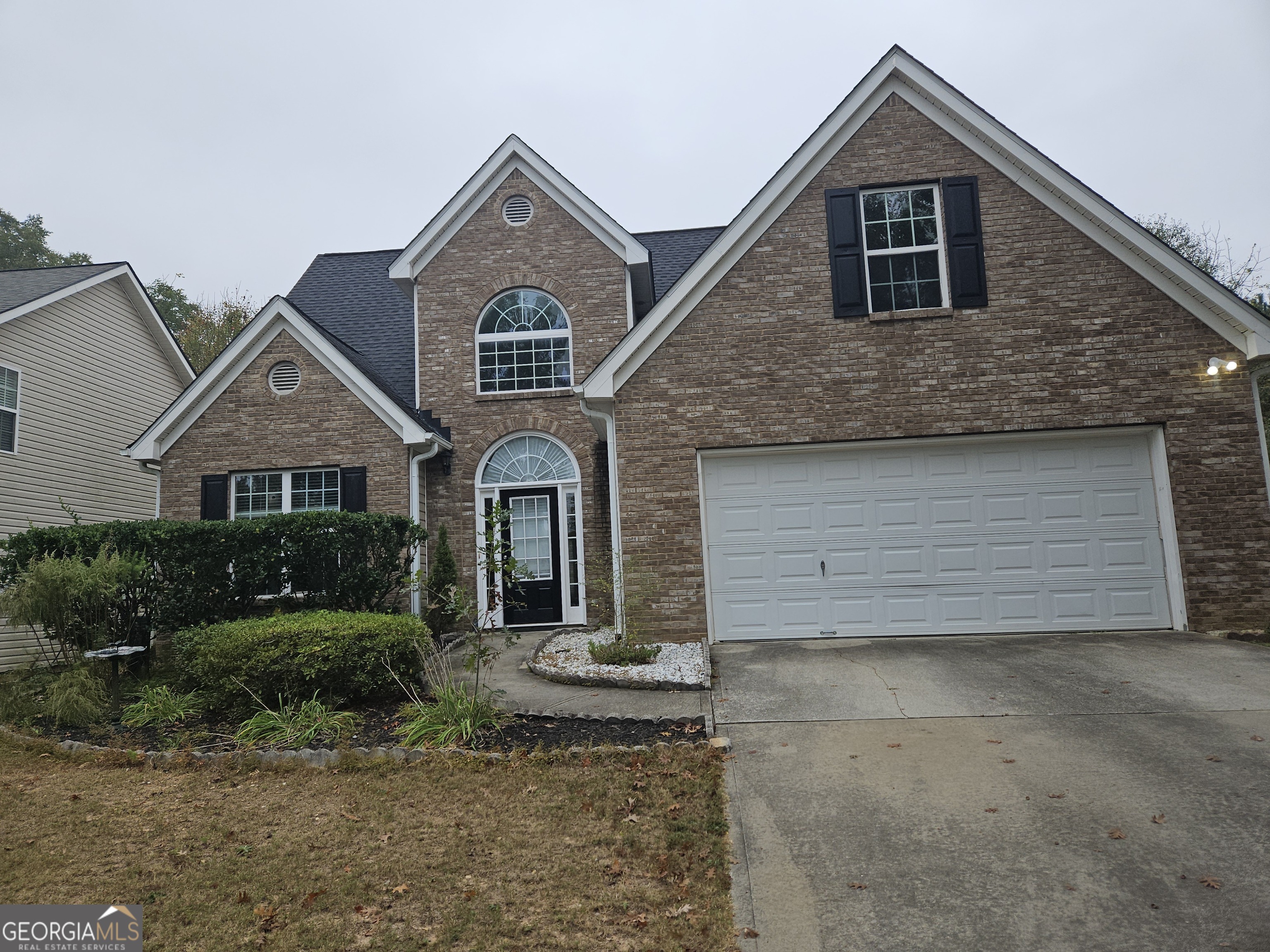 a front view of a house with a yard and garage