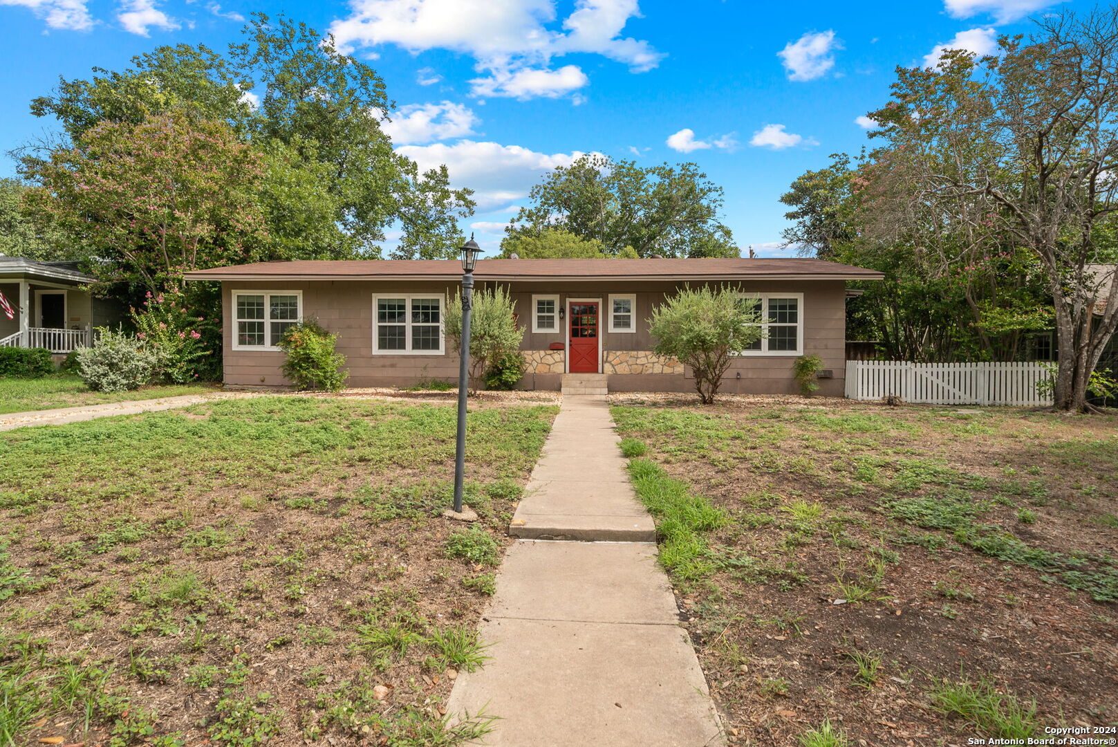 a front view of house with yard and green space