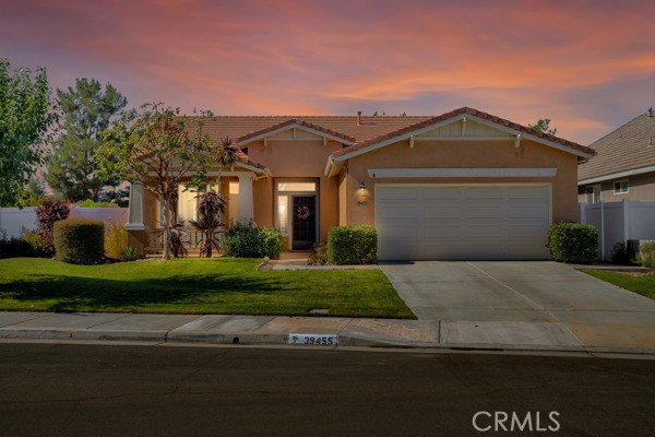 a front view of a house with a yard and a garage